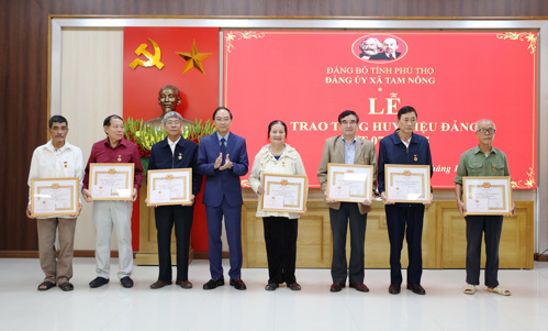 Đồng chí Đỗ Hùng Sơn - Phó Bí thư, Chủ tịch UBND xã trao Huy hiệu 45 năm tuổi Đảng cho các Đảng viên