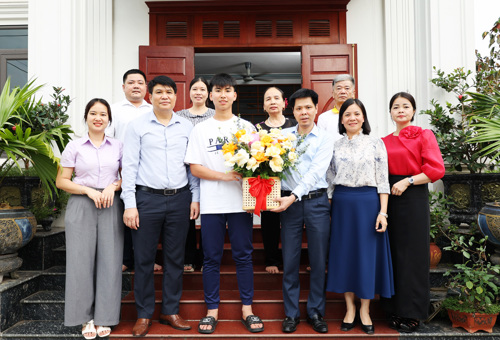 Đồng chí Nguyễn Tuấn Ngọc - Phó Bí thư Thường trực Đảng ủy xã Tam Nông tặng hoa chúc mừng cầu thủ Đào Quý Vương và gia đình