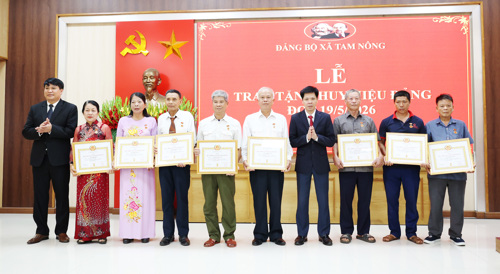 Đồng chí Nguyễn Tuấn Ngọc - PBT Thường trực Đảng ủy xã và đồng chí Nguyễn Khắc Long - UVBTV, Chủ tịch UBMTTQ xã trao Huy hiệu Đảng cho các đảng viên