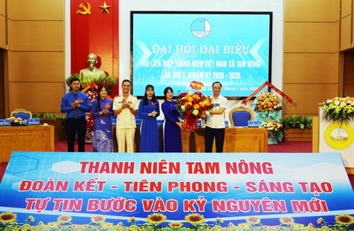 Đồng chí Hoàng Văn Dũng - Giám đốc Phòng Giao dịch Ngân hàng CSXH Tam Nông tặng hoa chúc mừng